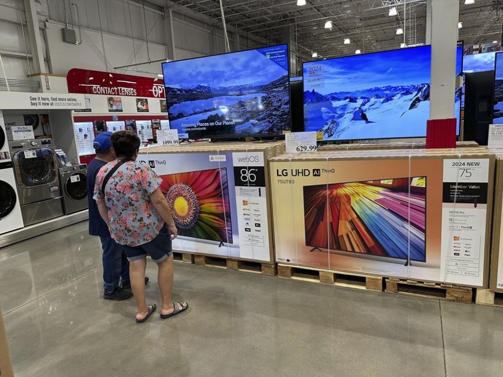 FILE - Shoppers consider big-screen televisions on display in a Costco warehouse Tuesday, Oct. 22, 2024, in Sheridan, Colo. (AP Photo/David Zalubowski, File)