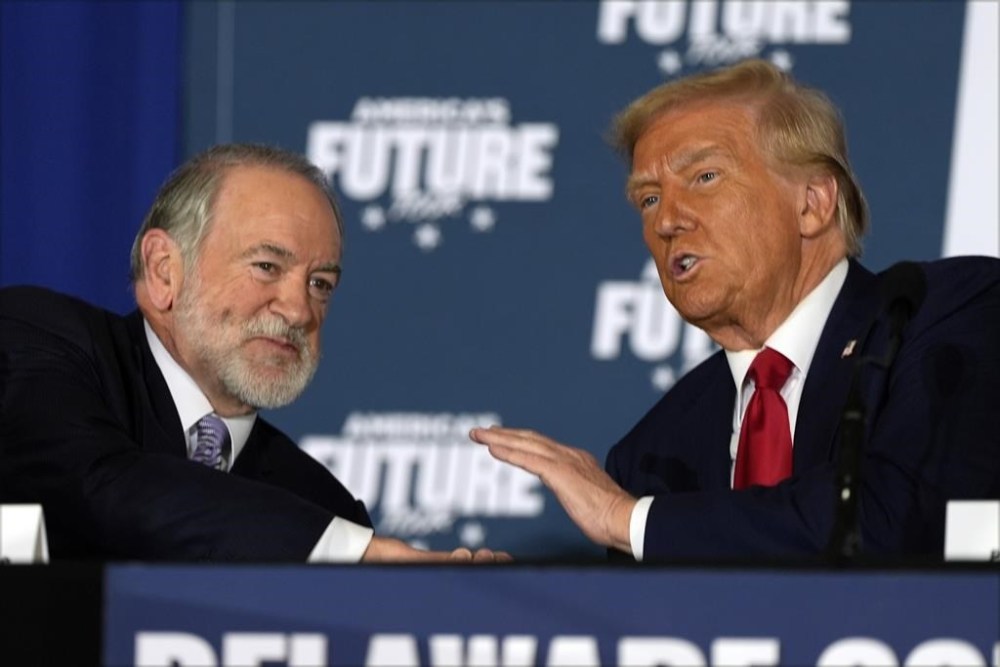 Republican presidential nominee former President Donald Trump talks with former Arkansas Gov. Mike Huckabee during a roundtable at the Drexelbrook Catering & Event Center, Tuesday, Oct. 29, 2024, in Drexel Hill, Pa. (AP Photo/Julia Demaree Nikhinson)