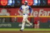FILE - Atlanta Braves' Travis d'Arnaud rounds second base after hitting a walkoff home run to win a baseball game against the Kansas City Royals, Sept. 28, 2024, in Atlanta. (AP Photo/Jason Allen, File)
