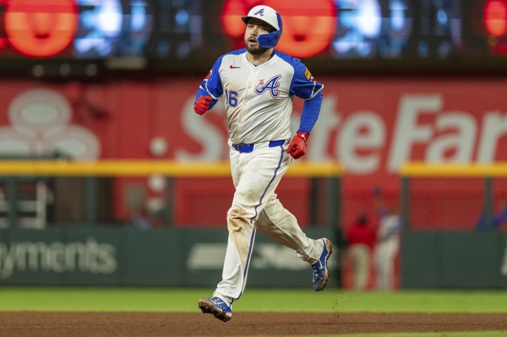 FILE - Atlanta Braves' Travis d'Arnaud rounds second base after hitting a walkoff home run to win a baseball game against the Kansas City Royals, Sept. 28, 2024, in Atlanta. (AP Photo/Jason Allen, File)