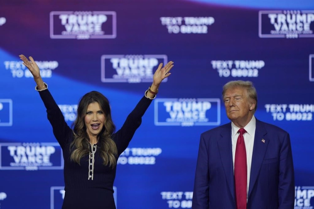 FILE - Republican presidential nominee former President Donald Trump and South Dakota Gov. Kristi Noem dance to the song