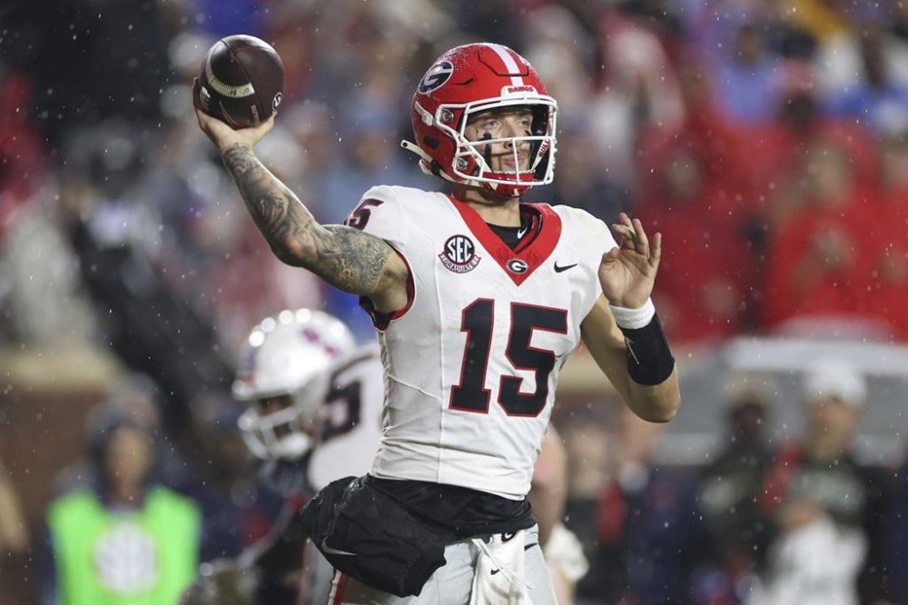 Georgia quarterback Carson Beck (15) throws the ball during the second half of an NCAA college football game against Mississippi on Saturday, Nov. 9, 2024, in Oxford, Miss. Mississippi won 28-10. (AP Photo/Randy J. Williams)