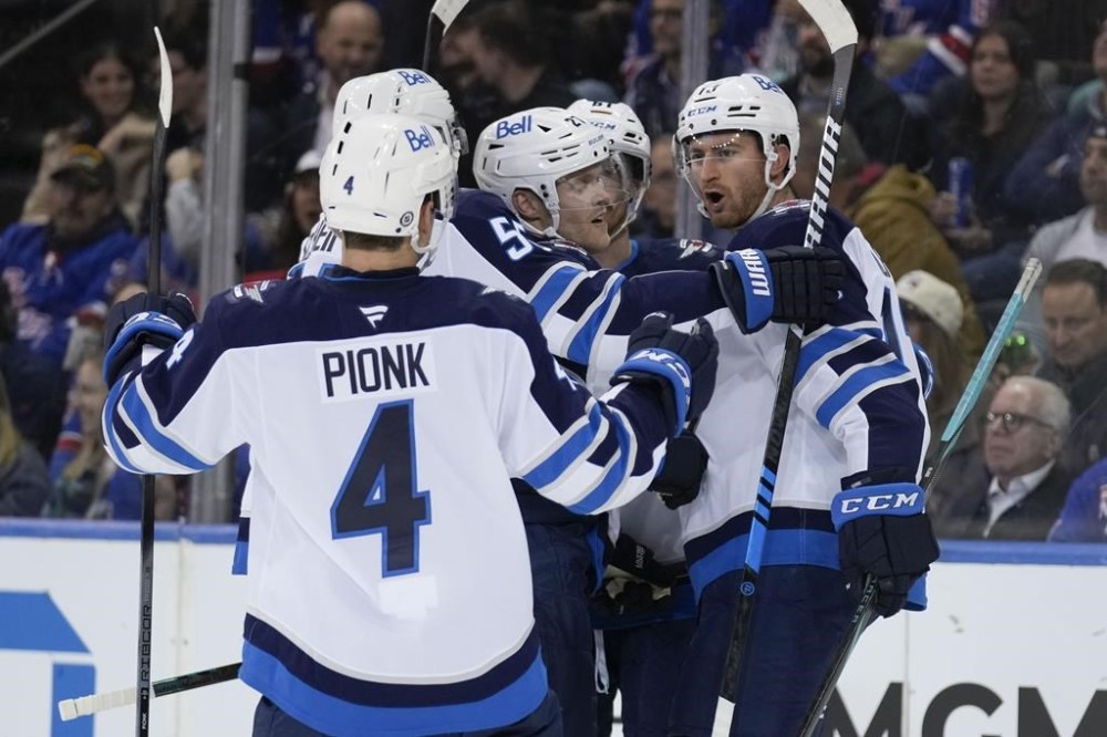 Winnipeg Jets' Gabriel Vilardi, right, celebrates his goal with teammates during the second period of an NHL hockey game against the New York Rangers Tuesday, Nov. 12, 2024, in New York. (AP Photo/Seth Wenig)