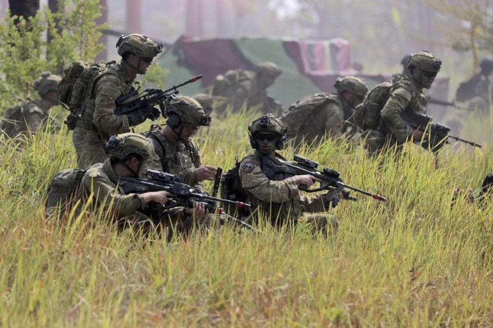 Australian soldiers take their positions during an Indonesia-Australia joint amphibious landing exercise on Banongan Beach, Situbondo, Indonesia, Wednesday, Nov. 13, 2024. (AP Photo/Trisnadi)