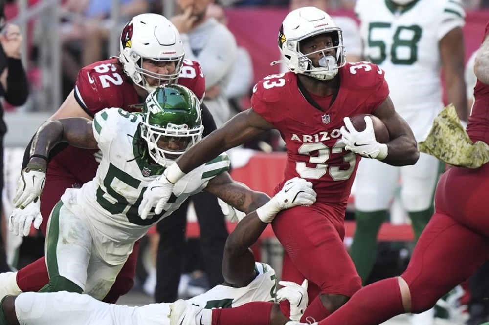 Arizona Cardinals running back Trey Benson (33) runs the ball against the New York Jets during the second half of an NFL football game, Sunday, Nov. 10, 2024, in Glendale, Ariz. (AP Photo/Brynn Anderson)