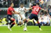 Real Madrid's Kylian Mbappe is challenged by Osasuna's Lucas Torro, left, and Osasuna's Alejandro Catena during the Spanish La Liga soccer match between Real Madrid and Osasuna at the Santiago Bernabeu stadium in Madrid, Spain, Saturday, Nov. 9, 2024. (AP Photo/Jose Breton)