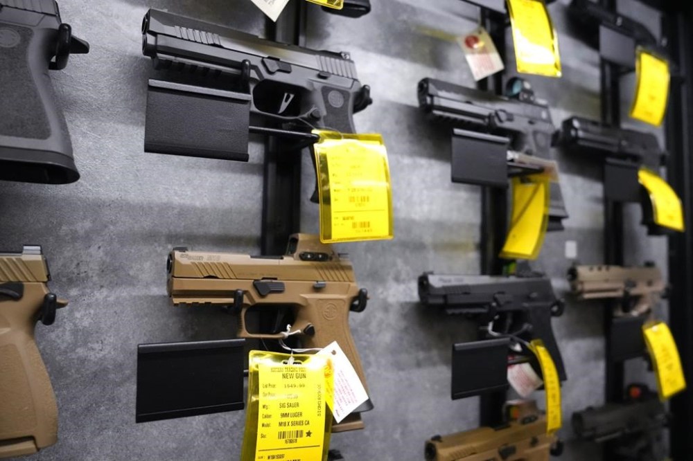 FILE - A selection of Sig Sauer pistols are displayed at the Kittery Trading Post, Aug. 9, 2024, in Kittery, Maine. (AP Photo/Charles Krupa, File)