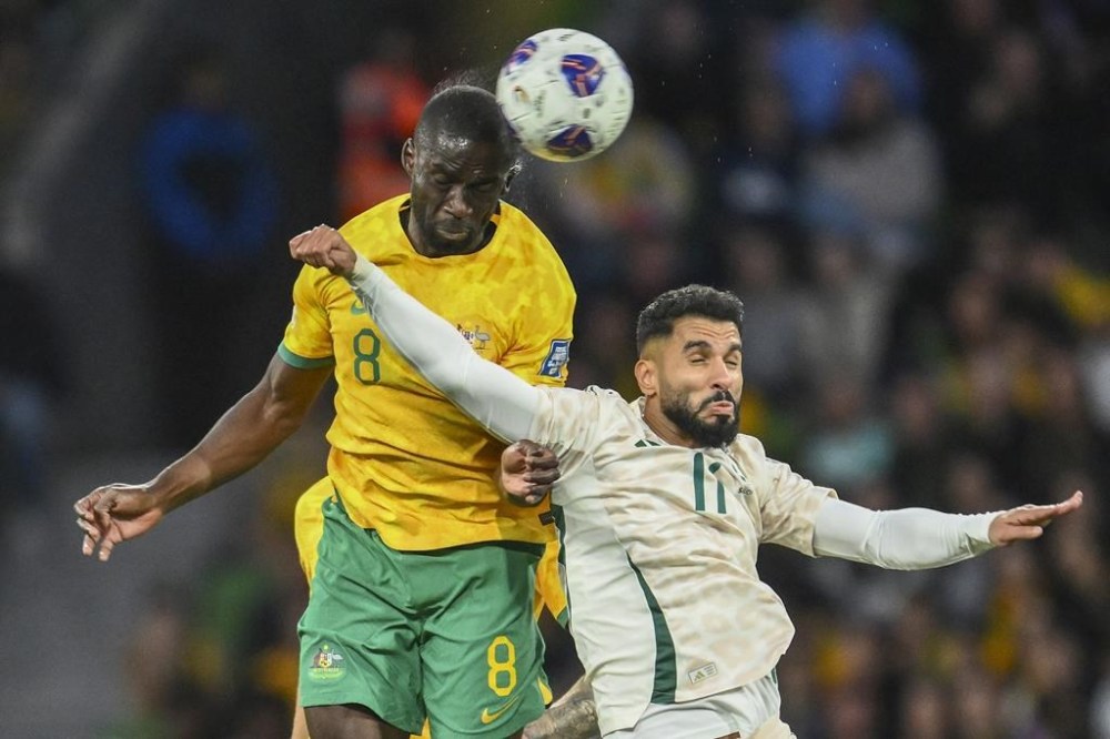 Australia's Jason Geria, left, and Saudi Arabia's Saleh Al Shehr compete for the ball compete for the ball during the 2026 World Cup qualifier between Australia and Saudi Arabia in Melbourne, Australia, Thursday, Nov. 14, 2024. (Joel Carrett/AAP Image via AP)