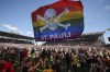 FILE - St. Pauli's fans invade the field after their team won 3-1 during a second division, Bundesliga soccer match at the Millerntor Stadium, in Hamburg, Germany, May 12, 2024. (Christian Charisius/dpa via AP File)