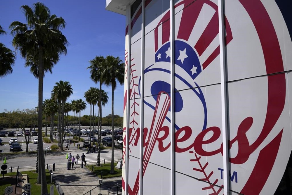 FILE - Fans arrive at George M. Steinbrenner Field for a spring training exhibition baseball game between the New York Yankees and the Pittsburgh Pirates in Tampa, Fla., Saturday, March 13, 2021. (AP Photo/Gene J. Puskar