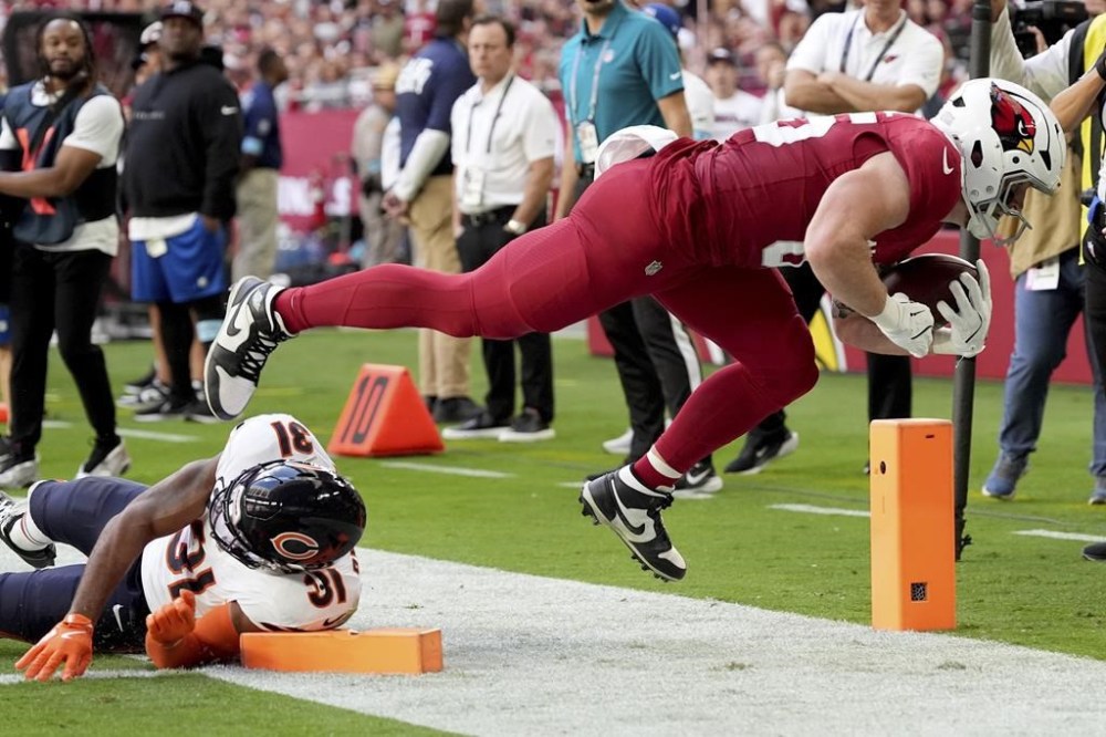 Arizona Cardinals tight end Trey McBride dives in for a touchdown as Chicago Bears safety Kevin Byard III (31) defends during the first half of an NFL football game, Sunday, Nov. 3, 2024, in Glendale, Ariz. (AP Photo/Ross D. Franklin)