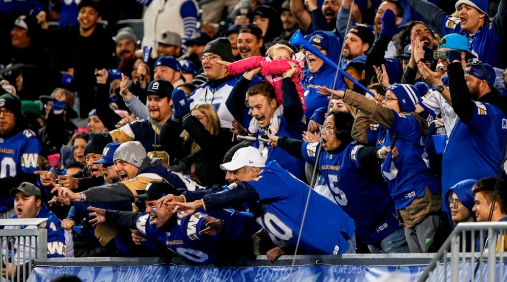 Winnipeg Blue Bombers fans celebrate a touchdown against the Saskatchewan Roughriders during the first half of CFL Western Conference Final action in Winnipeg Saturday, November 9, 2024. THE CANADIAN PRESS/John Woods