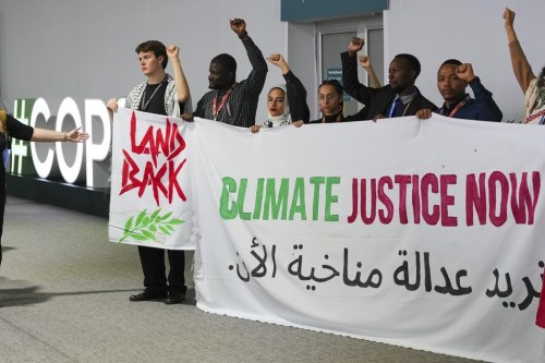 Activists demonstrate for climate justice and a ceasefire in the Israel-Hamas at the COP29 U.N. Climate Summit, Monday, Nov. 11, 2024, in Baku, Azerbaijan. (AP Photo/Peter Dejong)