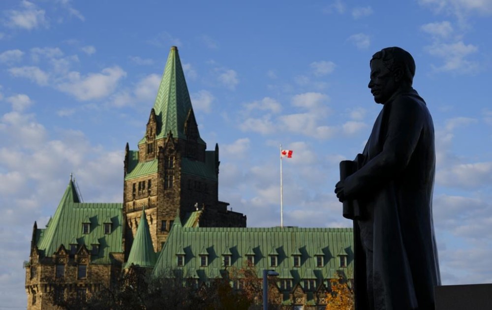 A statue of former prime minister Sir Robert Borden is backed by the Confederation Building on Parliament Hill in Ottawa on Thursday, Oct. 31, 2024. If no political party is willing to say uncle, the drawn-out stalemate in the House of Commons is headed for an unprecedented situation that could amount to a tacit lack of confidence in the government, without anyone in Parliament casting a vote. THE CANADIAN PRESS/Sean Kilpatrick