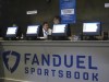 FILE - Workers at the FanDuel sports book at the Meadowlands Racetrack in East Rutherford, N.J., prepare to take bets, July 14, 2018. (AP Photo/Wayne Parry, File)