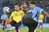 Colombia's Daniel Munoz (21) and Uruguay's Mathias Olivera battle for the ball during a qualifying soccer match for the FIFA World Cup 2026 in Montevideo, Uruguay, Friday, Nov. 15, 2024. (AP Photo/Santiago Mazzarovich)
