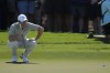 Rory McIlroy of Northern Ireland lines up a putt on the 1st green during the second round of World Tour Golf Championship in Dubai, United Arab Emirates, Saturday, Nov. 16, 2024. (AP Photo/Altaf Qadri)