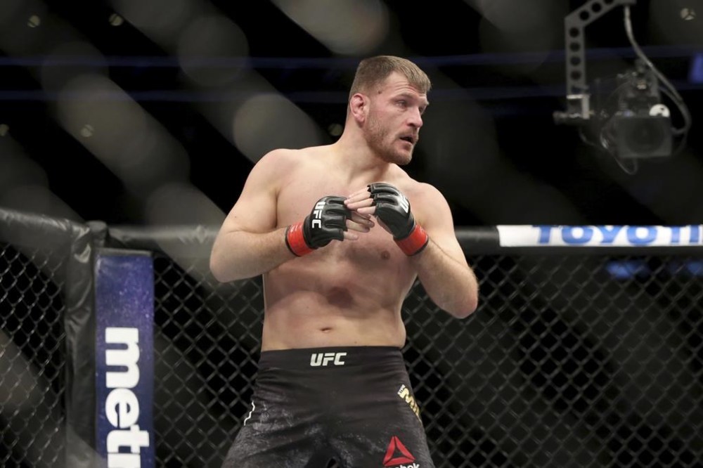 FILE - Stipe Miocic in action against Francis Ngannou during a heavyweight championship mixed martial arts bout at UFC 220, Sunday, Jan. 21, 2018, in Boston. (AP Photo/Gregory Payan, File)