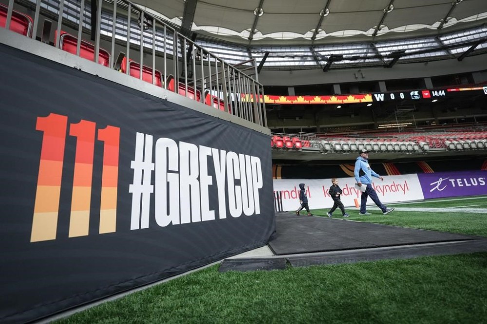 The Toronto Argonauts and Winnipeg Blue Bombers are set to battle for the Grey Cup on Sunday. Argonauts head coach Ryan Dinwiddie walks onto the field for football practice with his sons Cannon and Lancen, ahead of the 111th CFL Grey Cup in Vancouver, on Wednesday, November 13, 2024. THE CANADIAN PRESS/Darryl Dyck