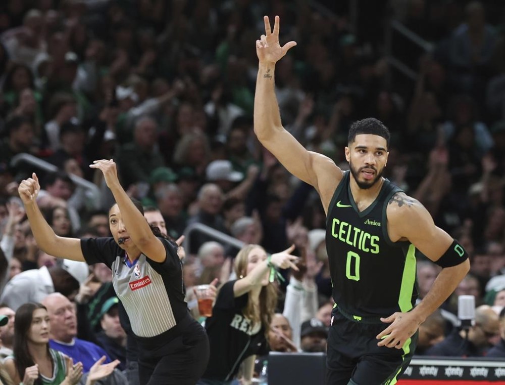 Boston Celtics forward Jayson Tatum (0) signals three after hitting an outside shot during the first half of an NBA basketball game against the Toronto Raptors, Saturday, Nov. 16, 2024, in Boston. (AP Photo/Mark Stockwell)