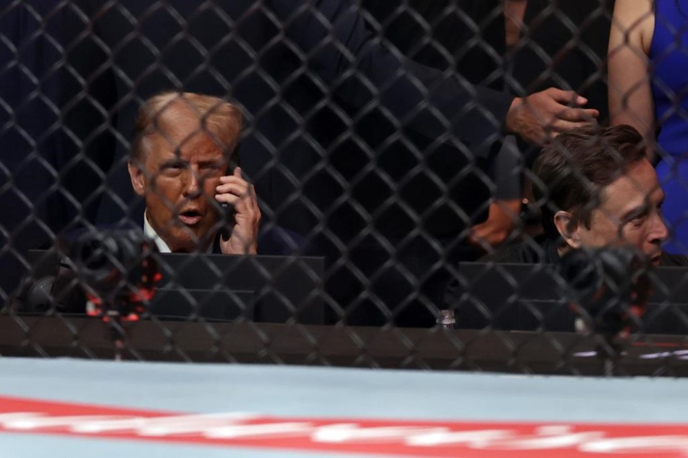 President-elect Donald Trump talks on the phone next to Elon Musk during a UFC 309 mixed martial arts flyweight title bout, Saturday, Nov. 16, 2024, in New York. (AP Photo/Adam Hunger)