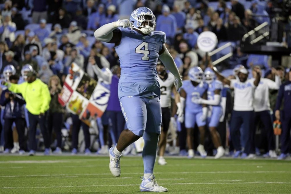 North Carolina defensive lineman Travis Shaw (4) celebrates after he stopped a Wake Forest runner during the second half of an NCAA college football game Saturday, Nov. 16, 2024, in Chapel Hill, N.C. (AP Photo/Chris Seward)