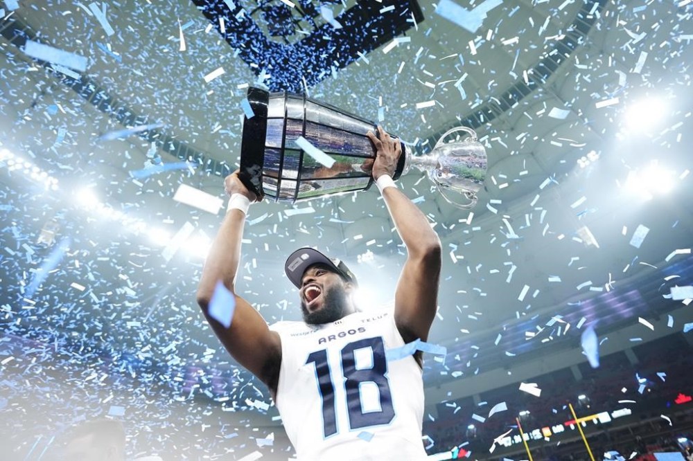 Toronto Argonauts' Dejon Brissett (18) lifts the Grey Cup after defeating the Winnipeg Blue Bombers in CFL football action at the 111th Grey Cup in Vancouver on Sunday, November 17, 2024. THE CANADIAN PRESS/Nathan Denette