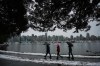 People use umbrellas while walking along the Stanley Park seawall as rain falls while a small amount of snow remains after last week's snowstorm, in Vancouver, Sunday, Dec. 25, 2022. A series of meteorological terms have become popularized in recent years. Here's how some of them are defined by the American Meteorological Society's glossary. THE CANADIAN PRESS/Darryl Dyck