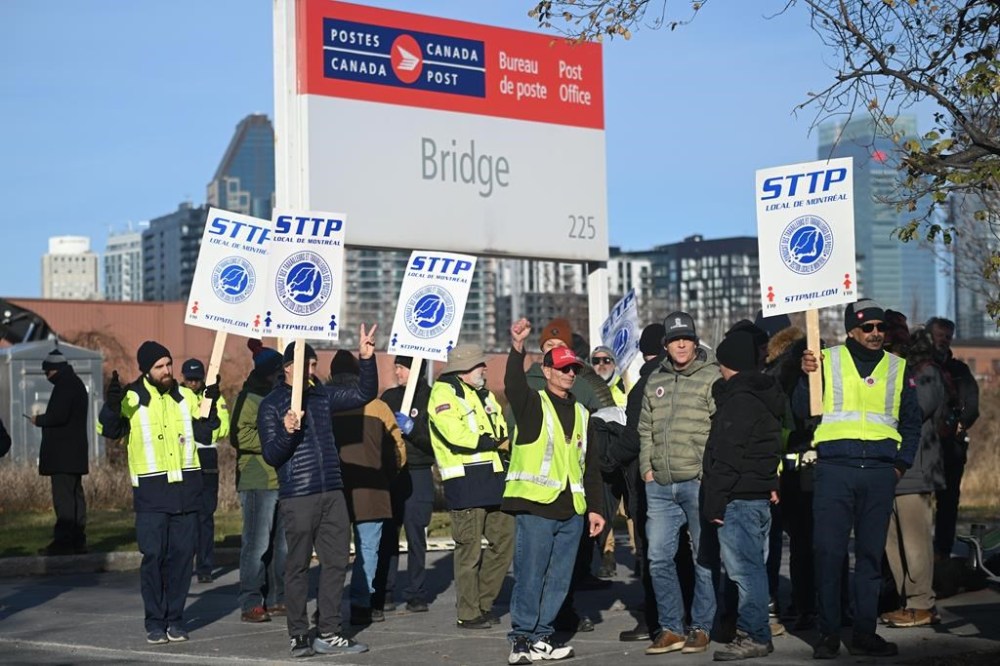 Canada Post workers picket outside a sorting plant in Montreal on Friday, Nov.15, 2024. Canadian Union of Postal Workers says approximately 55,000 workers are striking, claiming little progress has been made in the bargaining process. Representatives from Canada Post and the postal workers union sat down with a special mediator Monday, but seem no closer to reaching a deal as a countrywide strike enters its fifth day. THE CANADIAN PRESS/Graham Hughes