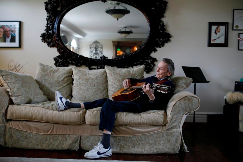 Canadian musician Gordon Lightfoot strums his guitar as he poses for a photograph in his Toronto home on Thursday, April 25, 2019. Gordon Lightfoot's treasured