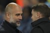 Manchester City's head coach Pep Guardiola, left, and Brighton's head coach Fabian Huerzeler talk before the English Premier League soccer match between Brighton and Manchester City at Falmer Stadium in Brighton, England, Saturday, Nov. 9, 2024. (AP Photo/Alastair Grant)