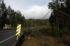 A tree rests on a power line on the Malahat Dr. on Highway 1 north of Victoria, B.C., on Wednesday. Severe weather conditions overnight left thousands without power across Vancouver Island. THE CANADIAN PRESS/Chad Hipolito