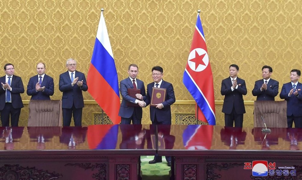 In this photo provided by the North Korean government, North Korea’s Foreign Minister of Economic Affairs Yoon Chung-ho, center right and Russia’s minister of natural resources and ecology Alexandr Kozlov, center left, shake hands at the signing ceremony of the protocol of the 11th meeting of the North Korea-Russia Intergovernmental Committee on Trade, Economy and Science and Technology Cooperation at Pyongyang , North Korea, Wednesday, Nov. 20, 2024. Independent journalists were not given access to cover the event depicted in this image distributed by the North Korean government. The content of this image is as provided and cannot be independently verified. Korean language watermark on image as provided by source reads: