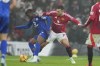 Manchester United's Diogo Dalot challenges for the ball with Leicester's Abdul Fatawu during the English Premier League soccer match between Manchester United and Leicester City, at the Old Trafford stadium in Manchester, England, Sunday, Nov.10, 2024. (AP Photo/Jon Super)