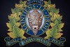 The RCMP logo is seen in Surrey, B.C., on Friday April 13, 2018. Manitoba RCMP have issued an arrest warrant for an Ontario truck driver who was allegedly involved in an accident that resulted in the death a woman and an eight-year-old girl. THE CANADIAN PRESS/Darryl Dyck