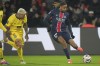 PSG's Bradley Barcola in action sin front of Toulouse's Aron Donnum during the French League One soccer match between Paris Saint-Germain and Toulouse at the Parc des Princes stadium in Paris, France, Sunday, Nov. 22, 2024. (AP Photo/Michel Euler)