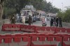 Police officers stand guard on an entry point to motorway leading to Islamabad, which has been closed by authorities due to a planned rally by supporters of imprisoned former Prime Minister Imran Khan's Pakistan Tehreek-e-Insaf party, in Lahore, Pakistan, Saturday, Nov. 23, 2024. (AP Photo/K.M. Chaudary)