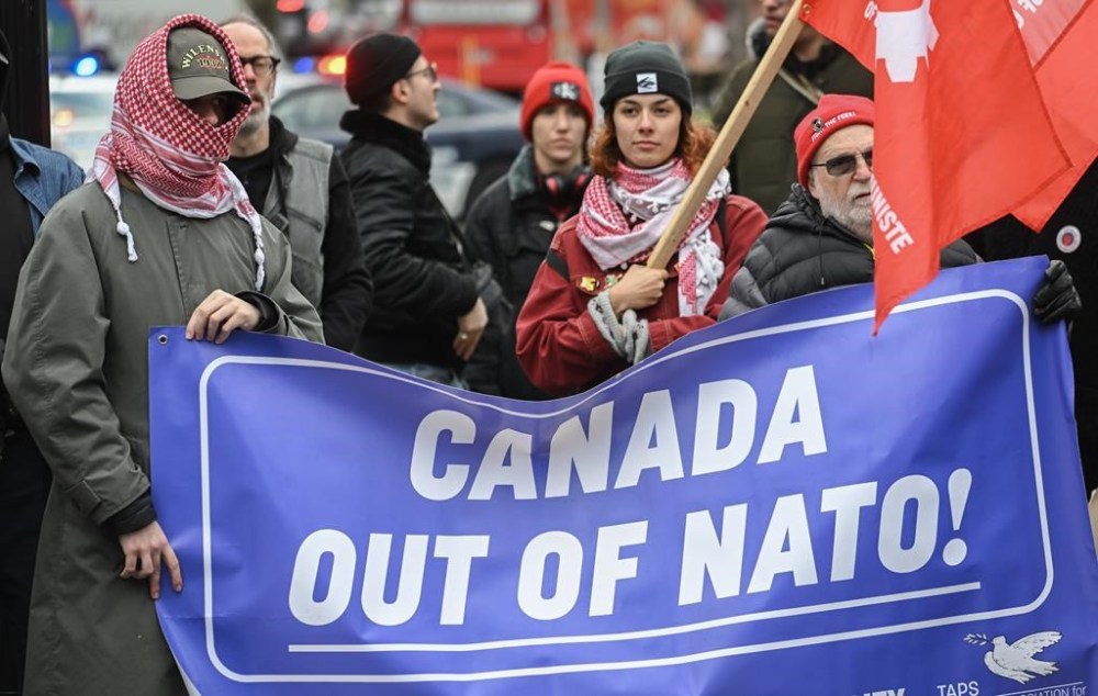 People take part in a protest against NATO in Montreal, Saturday, November 23, 2024. THE CANADIAN PRESS/Graham Hughes