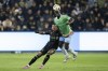 Seattle Sounders defender Yeimar Gómez (28) heads over Los Angeles FC forward Denis Bouanga (99) during the first half of an MLS Western Conference semifinal soccer match in Los Angeles, Saturday, Nov. 23, 2024. (AP Photo/Kyusung Gong)