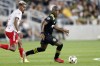 FILE - Columbus Crew midfielder Darlington Nagbe, right, controls the ball in front of New York Red Bulls forward Fabio during an MLS soccer match in Columbus, Ohio, on Sept. 14, 2021. (AP Photo/Paul Vernon, File)