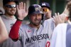 FILE - Minnesota Twins' Kyle Farmer celebrates in the dugout after scoring during the 10th inning of a baseball game against the Pittsburgh Pirates Sunday, June 9, 2024, in Pittsburgh. (AP Photo/Matt Freed, File)
