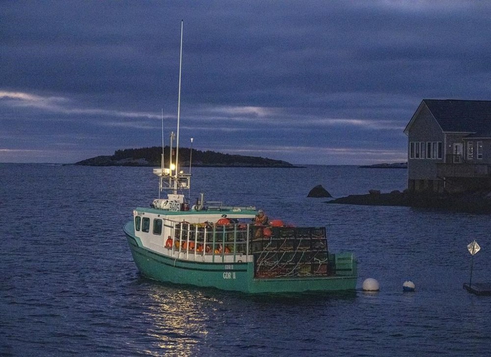 Lobster boats, loaded with pots and buoys, head from West Dover, N.S., on Nov. 29, 2022, for the opening of the season in lobster fishing area 33. THE CANADIAN PRESS/Andrew Vaughan