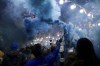 Argentine and Neapolitan fans light flares and sing to honor soccer legend Diego Armando Maradona on the anniversary of his death, at the Quartieri Spagnoli neighborhood, in Naples, Italy, Monday, Nov. 25, 2024. (Alessandro Garofalo/LaPresse via AP)