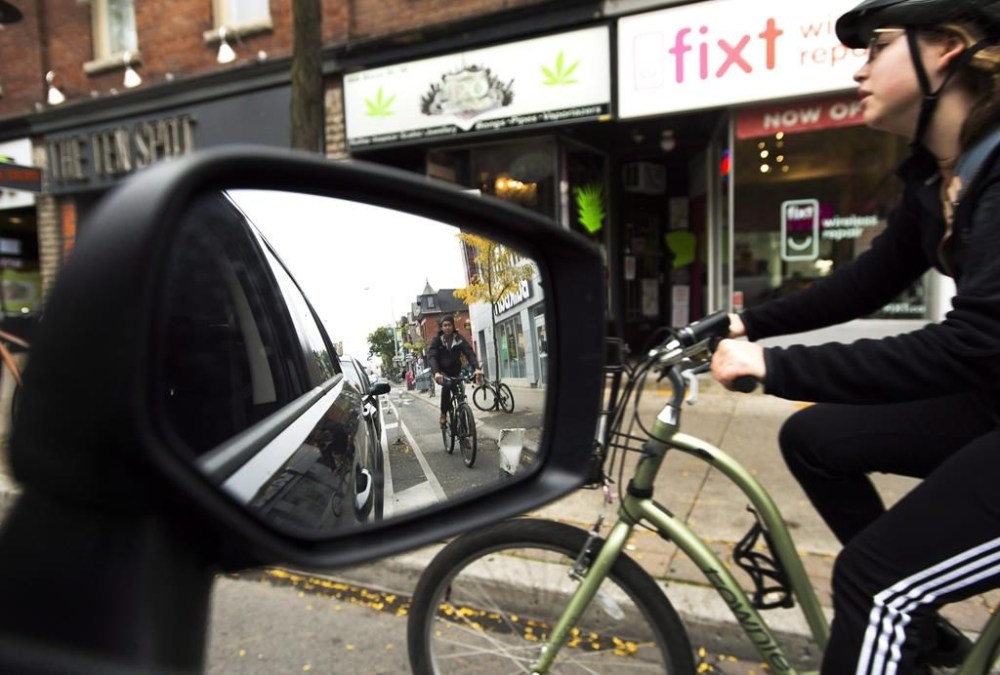 Cyclists ride on the designated Bloor Street bike lanes in Toronto on October 12, 2017. THE CANADIAN PRESS/Nathan Denette