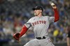 FILE - Boston Red Sox relief pitcher Cam Booser throws to a Kansas City Royals batter during the ninth inning of a baseball game against the Kansas City Royals, Monday, Aug. 5, 2024, in Kansas City, Mo. (AP Photo/Reed Hoffmann, File)