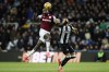 West Ham United's Michail Antonio, left, and Newcastle United's Lloyd Kelly, right, challenge for the ball during the English Premier League soccer match between Newcastle United and West Ham United in Newcastle, England, Monday, Nov. 25, 2024. (Richard Sellers/PA via AP)