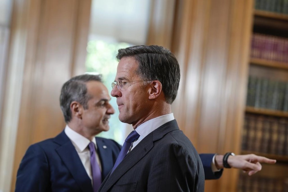 NATO Secretary General Mark Rutte, right, looks on in front of Greek Prime Minister Kyriakos Mitsotakis, right, prior to their meeting in Athens, on Tuesday, Nov. 26, 2024.(AP Photo/Petros Giannakouris)