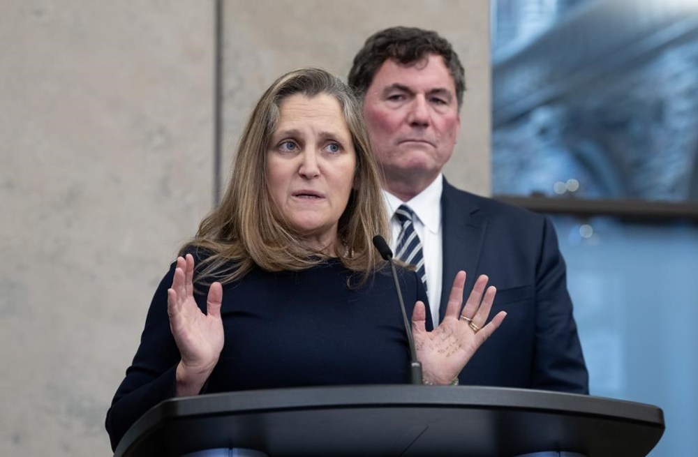 Minister of Public Safety, Democratic Institutions and Intergovernmental Affairs Dominic LeBlanc looks on as Deputy Prime Minister and Minister of Finance Chrystia Freeland speaks to reporters following cabinet meeting on Parliament Hill, in Ottawa, Tuesday, Nov. 26, 2024. THE CANADIAN PRESS/Adrian Wyld