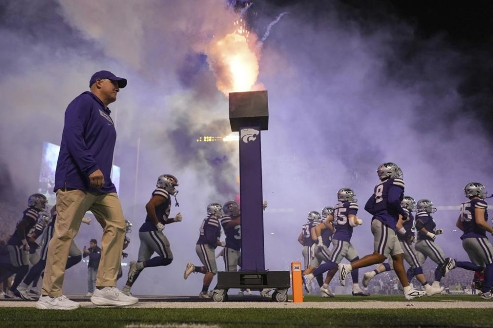 Kansas State head coach Chris Klieman walks onto he field with his palyers before an NCAA college football game against Arizona State Saturday, Nov. 16, 2024, in Manhattan, Kan. (AP Photo/Charlie Riedel)
