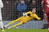 Liverpool's goalkeeper Caoimhin Kelleher stops a penalty shot from Real Madrid's Kylian Mbappe during the Champions League opening phase soccer match between Liverpool and Real Madrid at Anfield Stadium, Liverpool, England, Wednesday, Nov. 27, 2024. (AP Photo/Jon Super)
